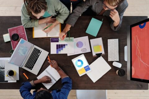 A team of office employees discussing content marketing goals